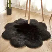 Cloud shape faux wool area rug in black, adding modern style and comfort to a cozy living space.